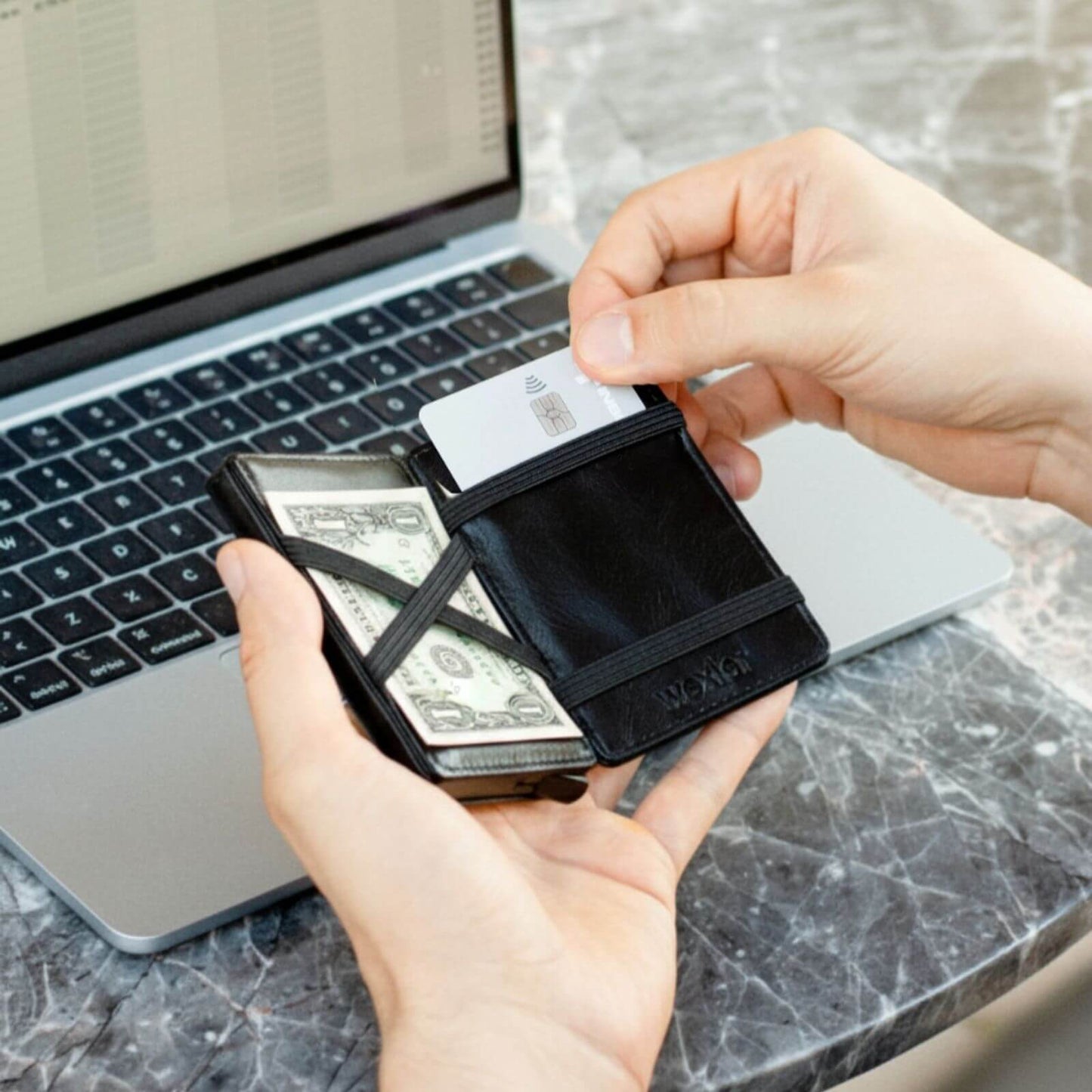 Wex Magic Wallet on coffee table with cash and cards